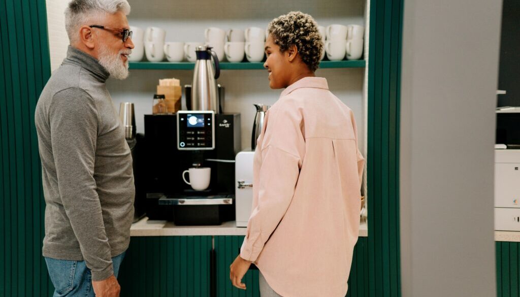 Co-workers at the coffee machine in an office