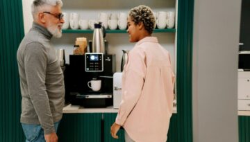 Co-workers at the coffee machine in an office