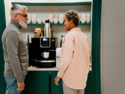 Co-workers at the coffee machine in an office