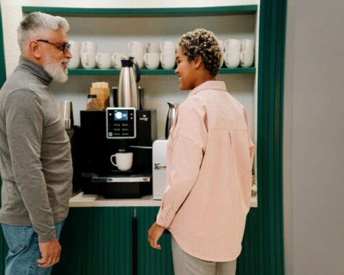 Co-workers at the coffee machine in an office